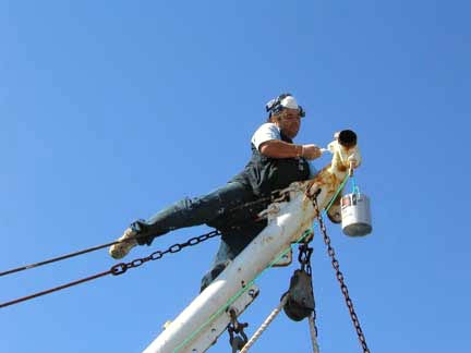 Patinting the mast of fishing boat